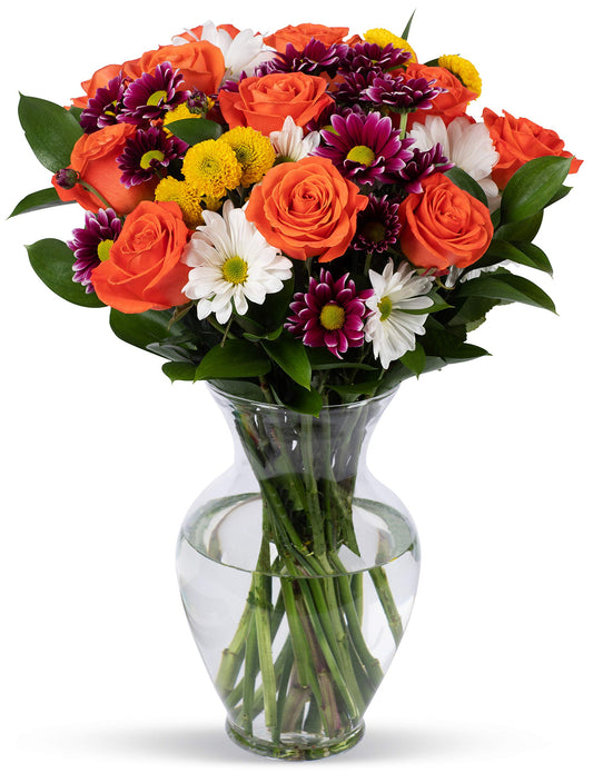 Vibrant orange bouquet with roses and chrysanthemums in a glass vase, supporting the Life is Good Kids Foundation.