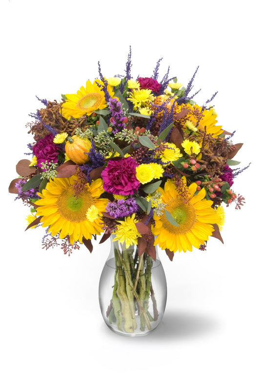 Vibrant autumn bouquet with seasonal flowers in a vase, showcasing rich fall hues for festive occasions and elegant spaces.