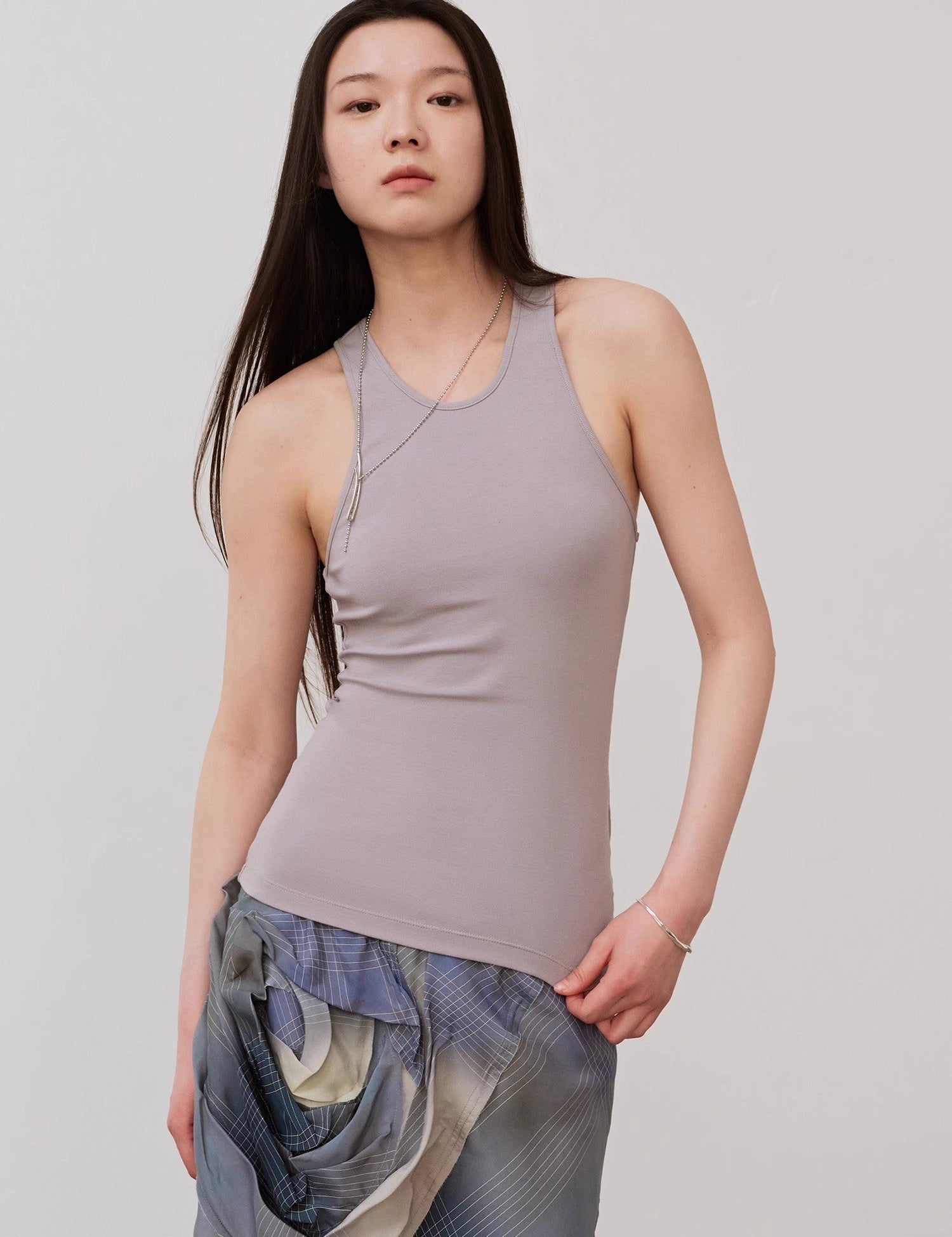 Woman wearing Isvera Slim Cotton Camisole with I-shaped neckline, highlighting elegant summer style and breathable softness.