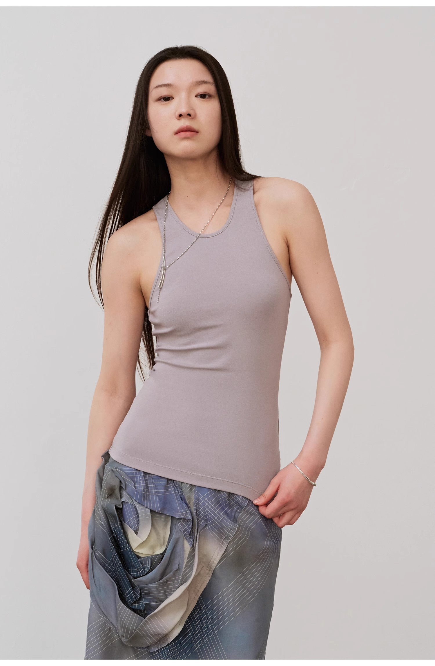 Woman wearing Isvera Slim Cotton Camisole with I-shaped neckline, highlighting elegant summer style and breathable softness.
