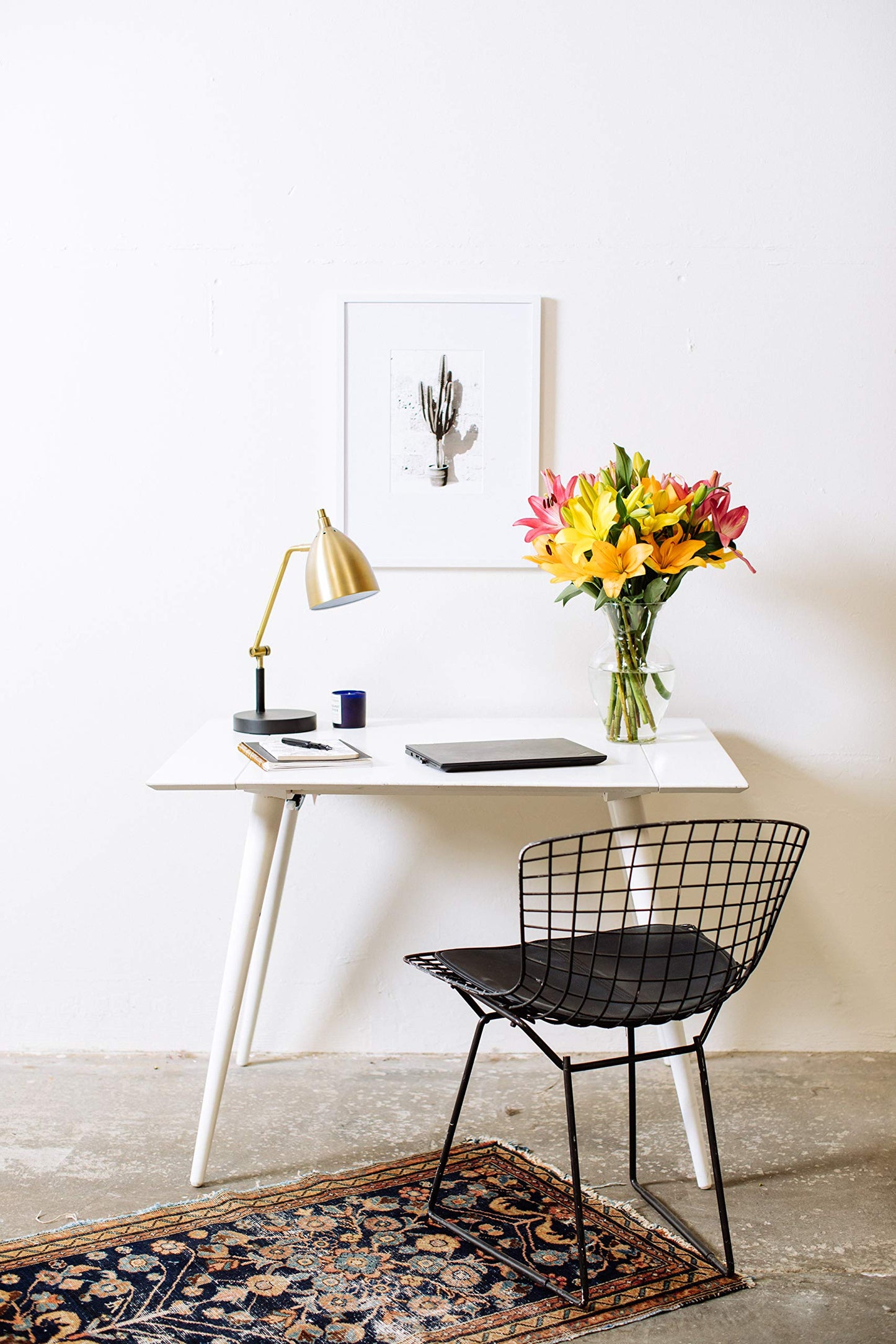 Modern desk setup with 12-stem Asiatic lilies bouquet in a glass vase, adding elegance to a workspace.