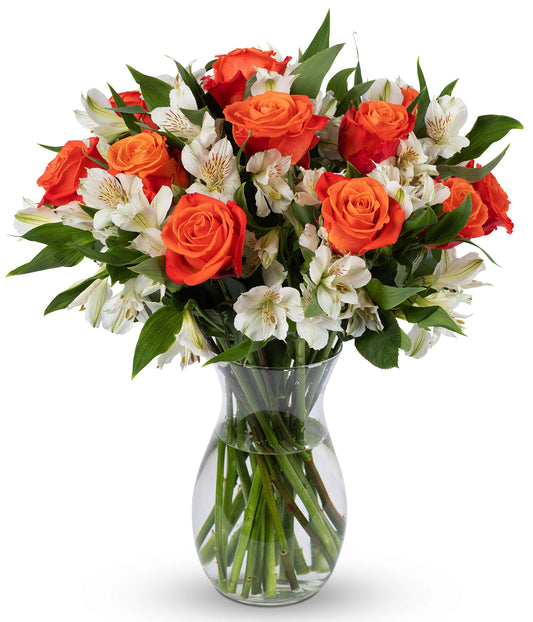 Vibrant bouquet of orange roses and white alstroemeria in a clear glass vase, perfect for any occasion.