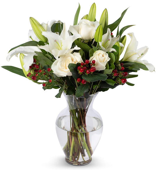 White Elegance Bouquet with oriental lilies, roses, and seasonal greens in a glass vase, perfect for weddings or heartfelt gifts.