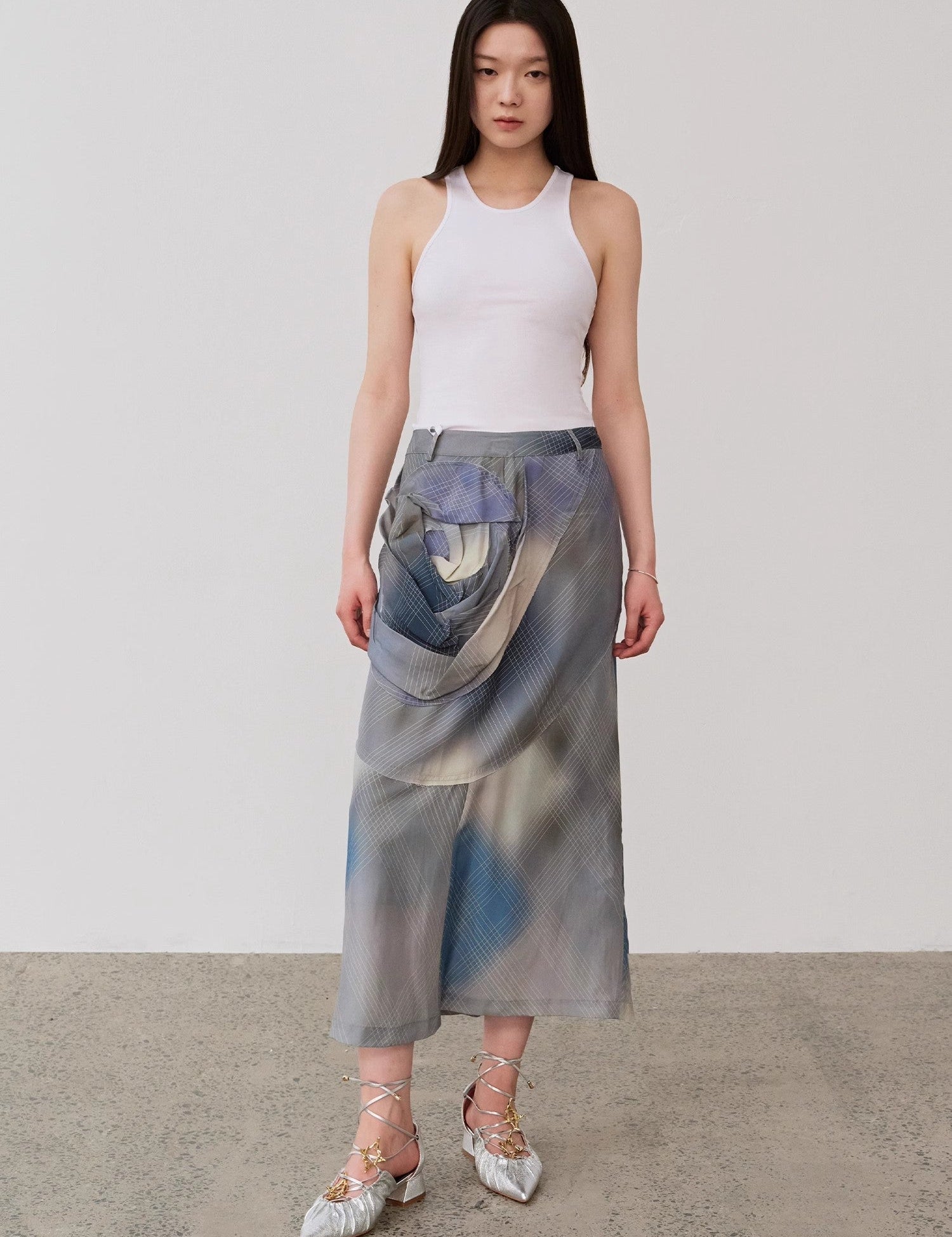 Model wearing Isvera slim cotton camisole with stylish long skirt and silver shoes, showcasing a modern, polished look.