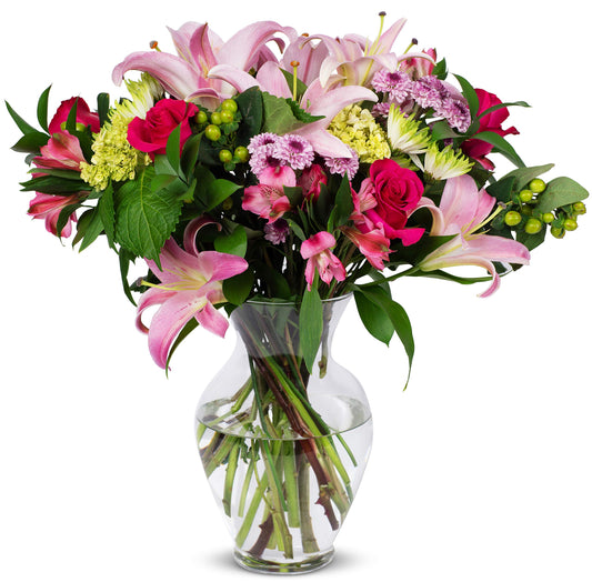 Blissful Blossoms bouquet with pink lilies, hot-pink roses, hydrangeas, and greenery in a glass vase. Perfect for any occasion.