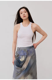 Woman wearing Isvera Slim Cotton Camisole with I-shaped neckline and stylish skirt, showcasing summer fashion elegance.