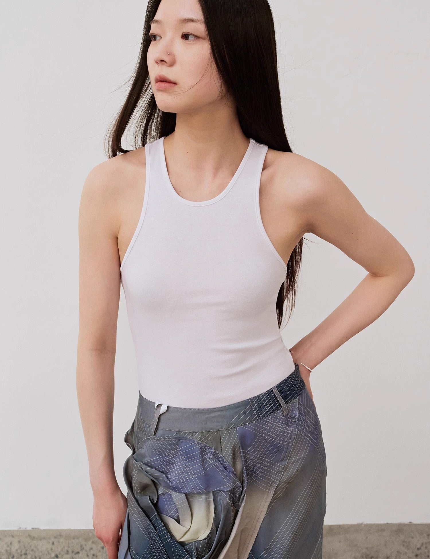 Woman wearing Isvera Slim Cotton Camisole, showcasing a fitted design with an elegant I-shaped neckline, perfect for summer wear.