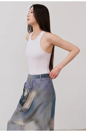 Woman wearing Isvera Slim Cotton Camisole with I-shaped neckline, styled with a flowing patterned skirt for a chic summer look.