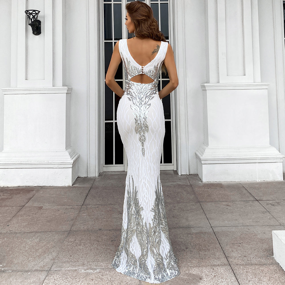 Woman wearing Starlit Mirage Mesh Gown in white with silver sequin detailing, showcasing the elegant back design.