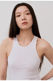 Woman wearing Isvera Slim Cotton Camisole showcasing its breathable, slim fit and I-shaped neckline.
