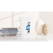 17oz white ceramic latte mug with customizable design placed on a table with books and decorative vases; perfect for coffee or latte.