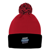 Red knit pom beanie with black fold-over cuff for custom embroidery, featuring playful pom-pom and warm acrylic fabric.