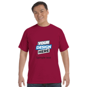 Person wearing a maroon Print on Demand Durmor heavyweight T-shirt with "Your Design Here" print, showcasing custom design option.