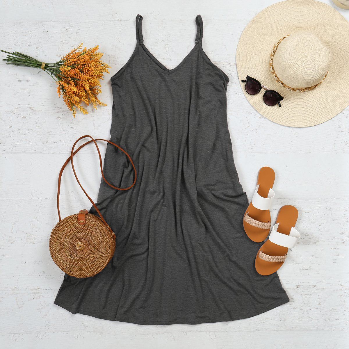 Maribel V-Neck Swing Dress with accessories, featuring sandals, sunhat, sunglasses, and a woven purse, perfect for spring outings.