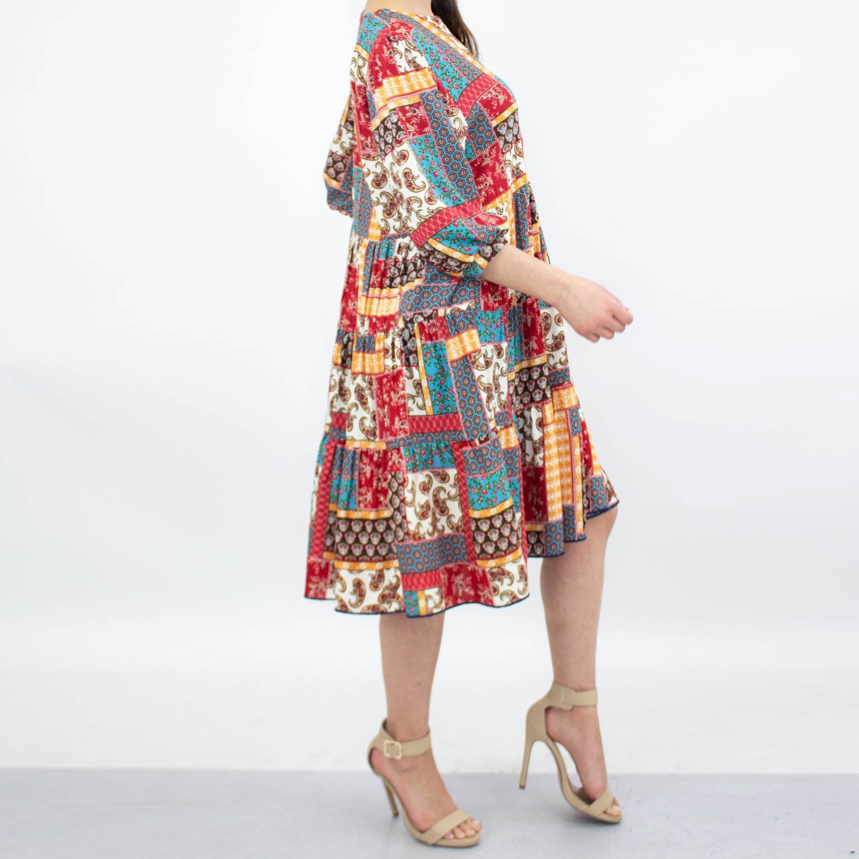 4 sleeves, flared skirt, and beige heels.