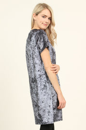 Model wearing Calyn Crushed Velvet Tunic Dress in gray, featuring a relaxed fit and short sleeves.