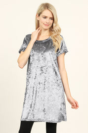 Woman wearing Calyn Crushed Velvet Tunic Dress in gray with short sleeves and crew neckline.
