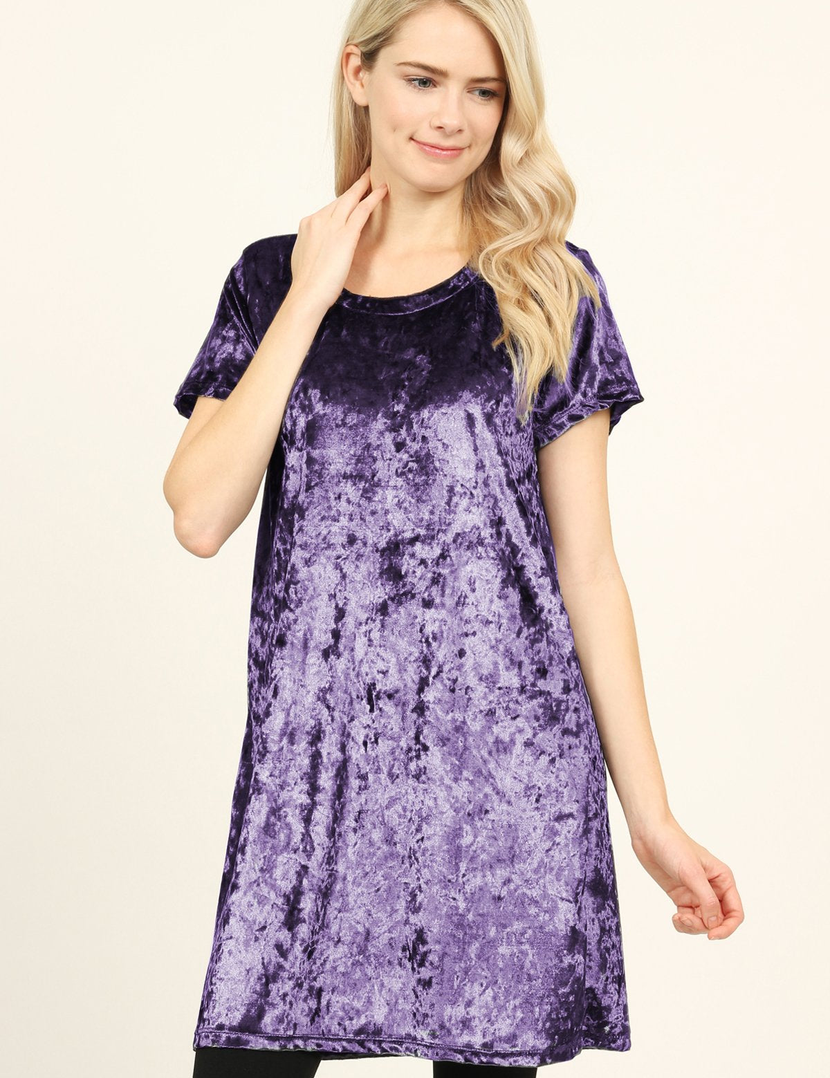 Woman wearing a purple Calyn Crushed Velvet Tunic Dress with short sleeves and a relaxed fit.
