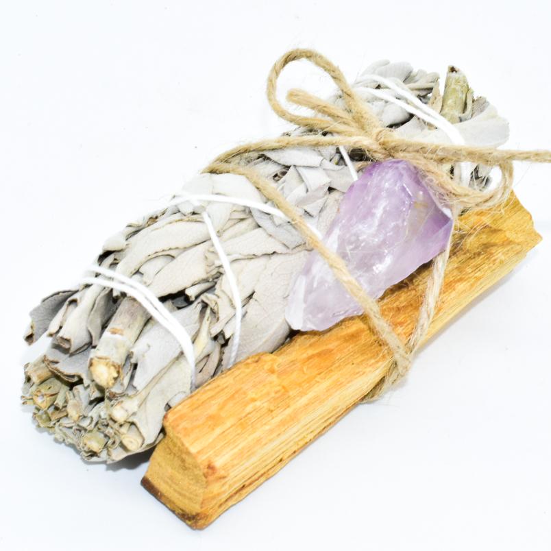 Palo Santo, sage, and crystal bundle for spiritual cleansing and renewal. Includes white sage, Palo Santo stick, and purple crystal.