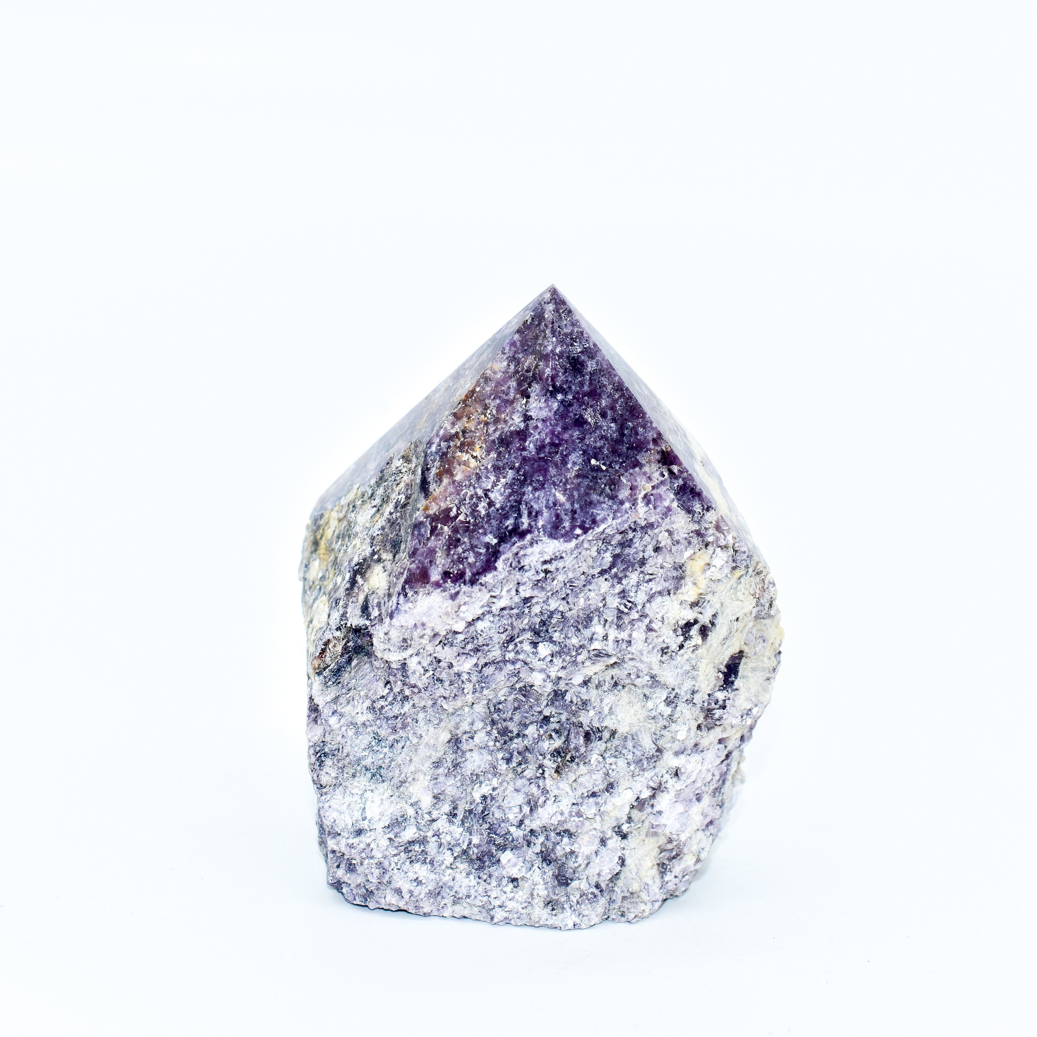 Vibrant lepidolite power point with polished peak and raw base, known for easing stress and promoting restful sleep.