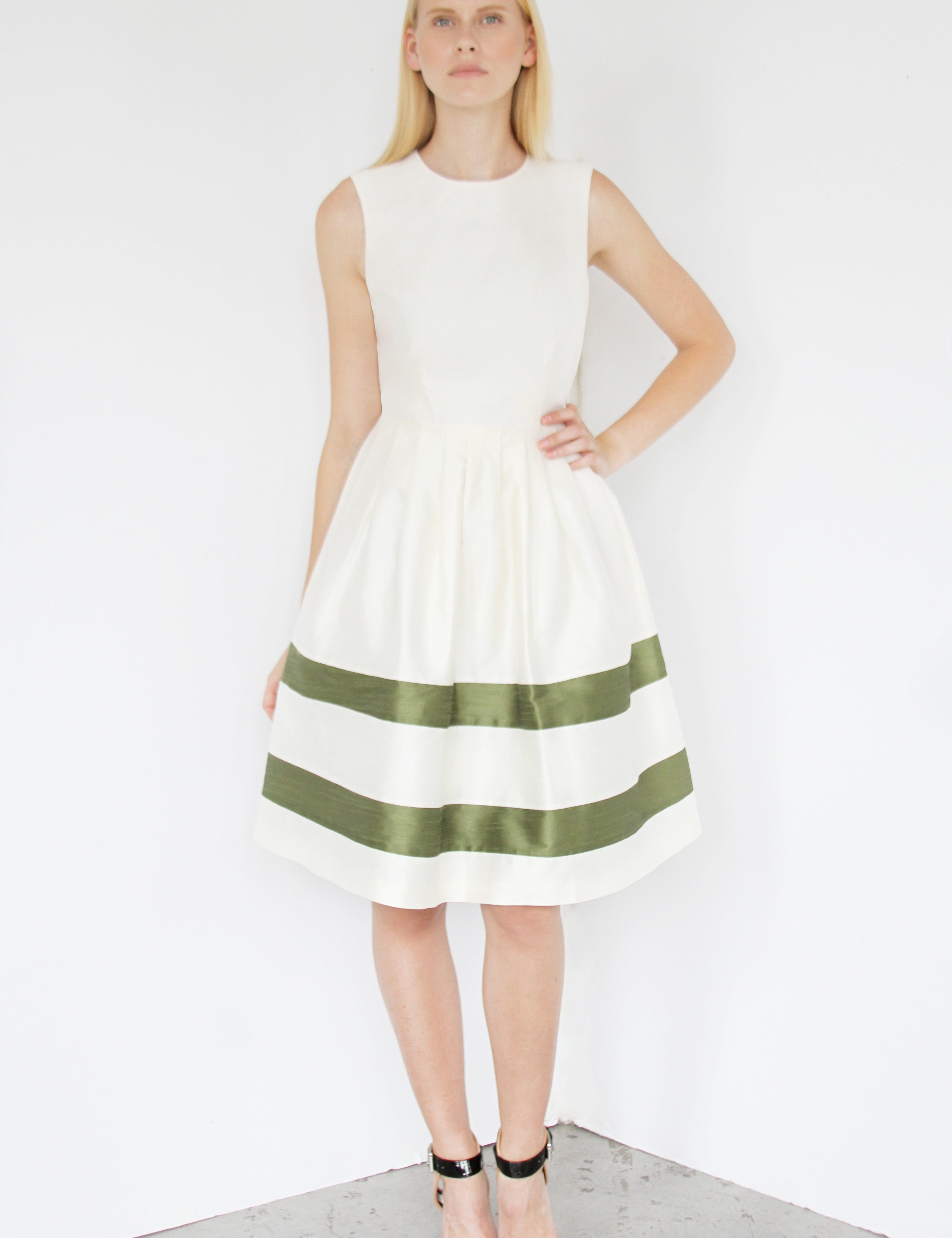 Model wearing Stripe Reverie Dupioni Dress with horizontal stripes and fitted bodice, featuring a full skirt and open waist pleats.