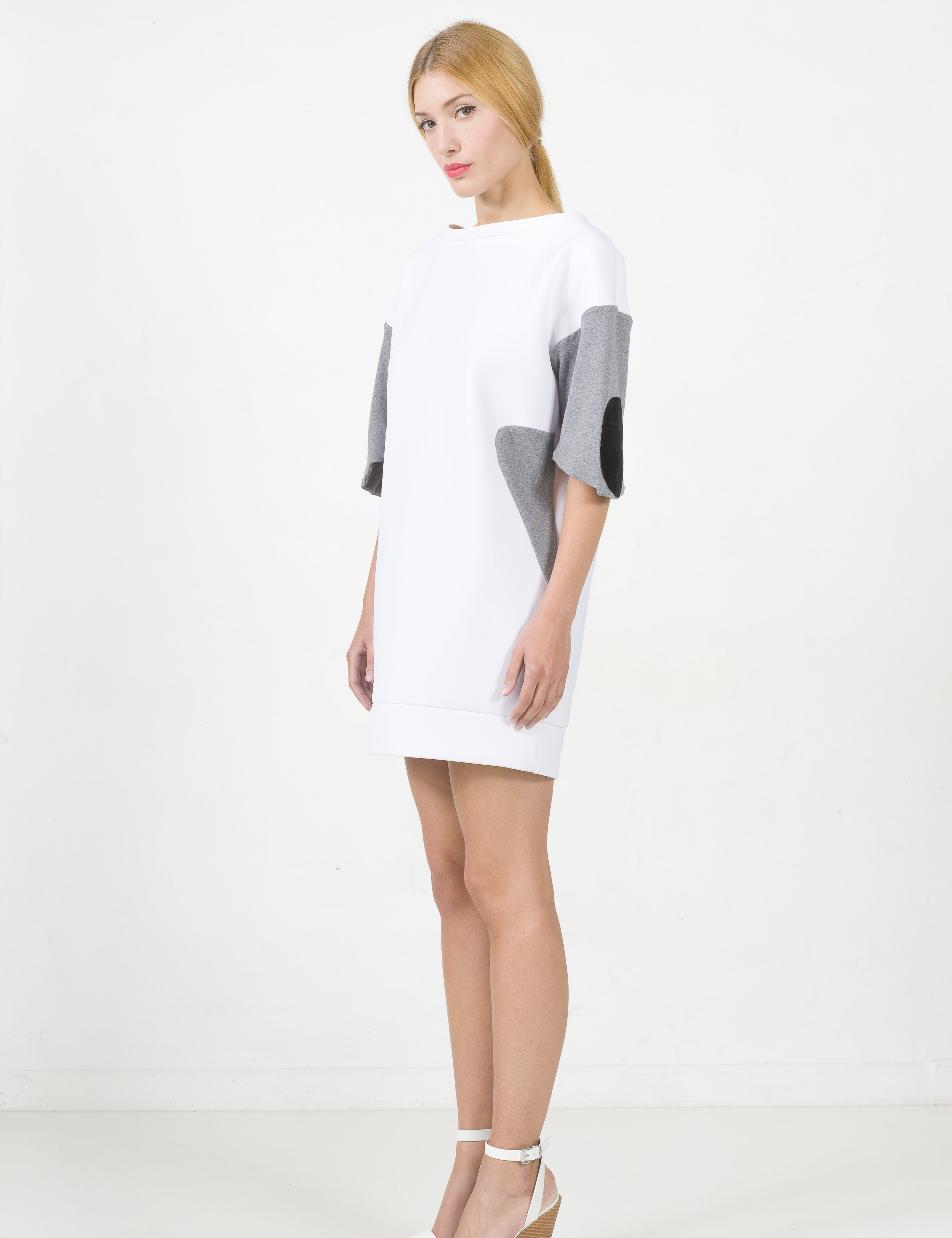Woman wearing Lorvien White Neoprene Panel Dress with grey panels, showing minimalist and modern design.