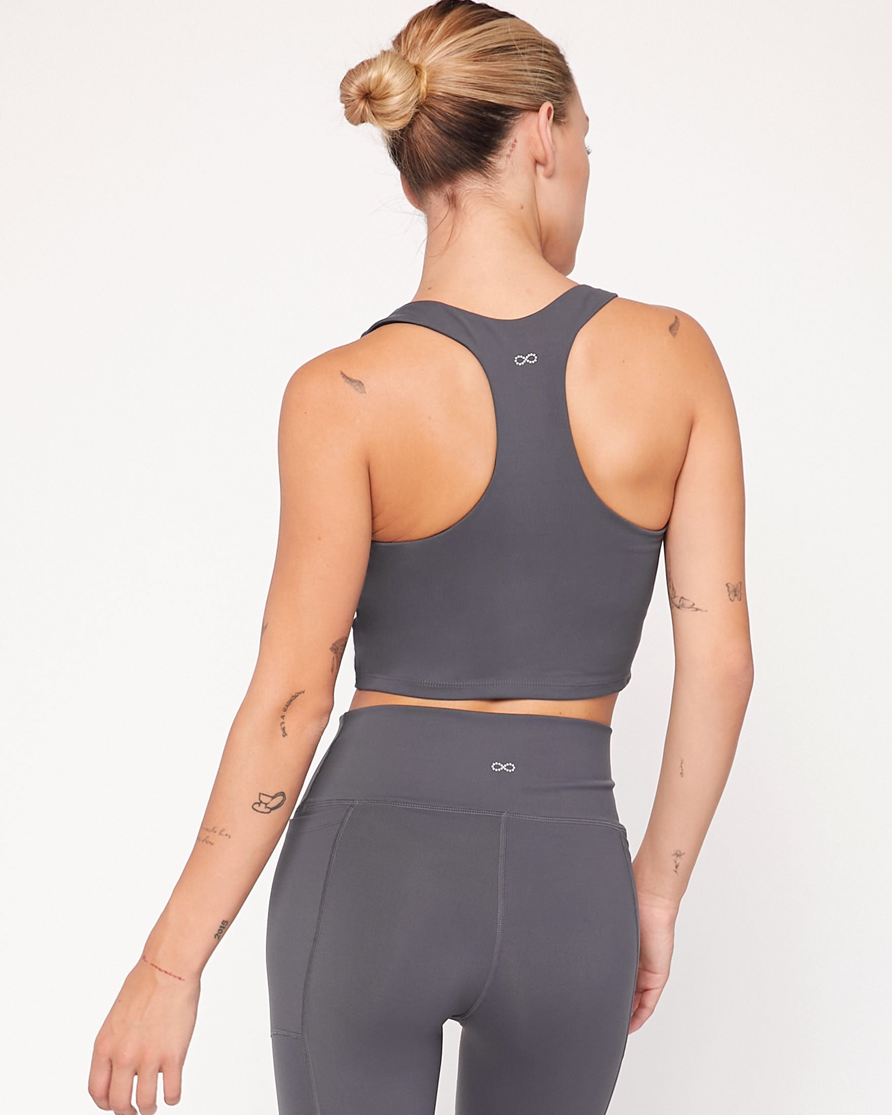 Back view of woman wearing Anvera Motionline Bra, showcasing racerback design and smooth longline fit, ideal for active wear.