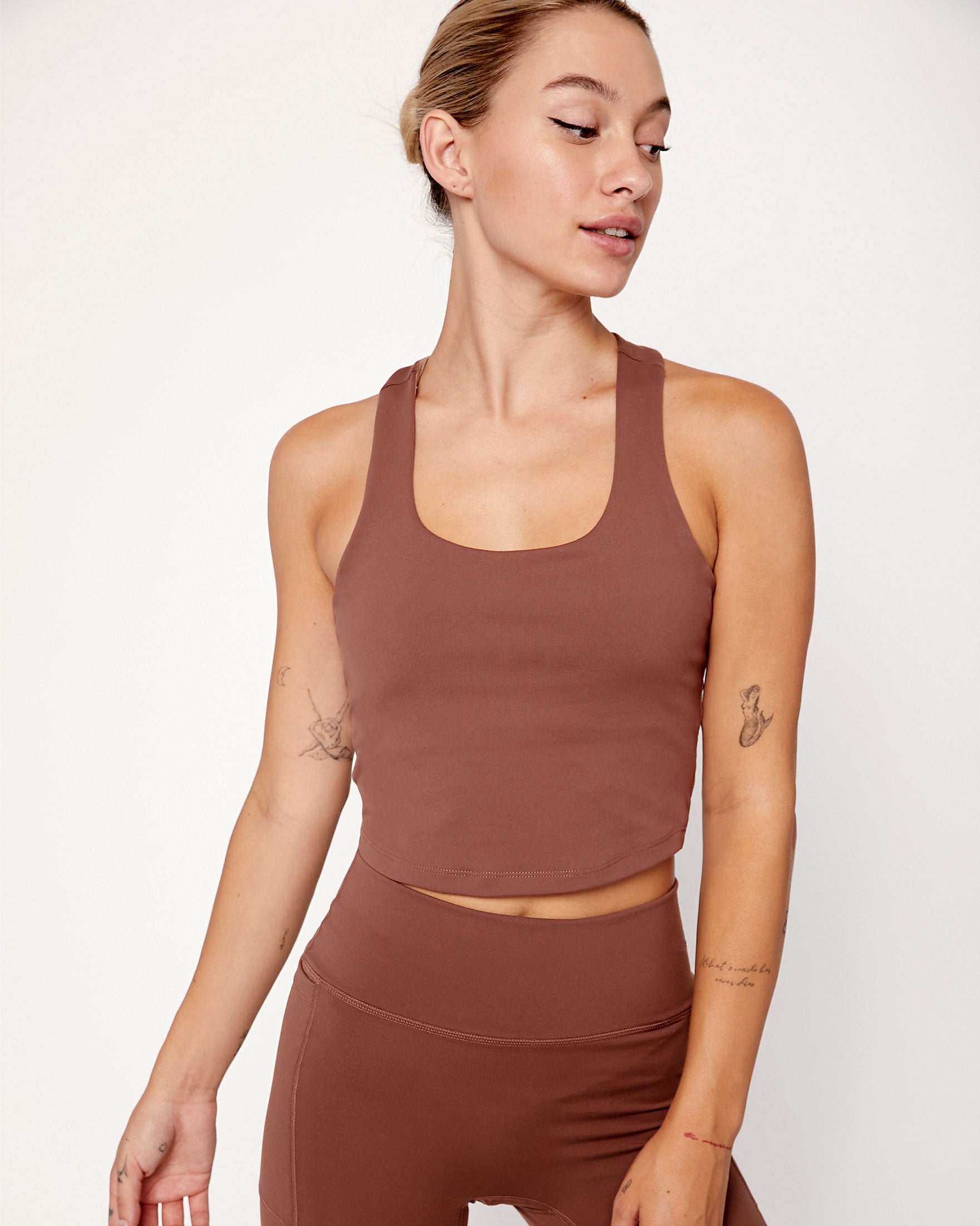 Woman wearing Anvera Motionline Bra with a sculpted design and racerback, showcasing its supportive and stylish longline cut.