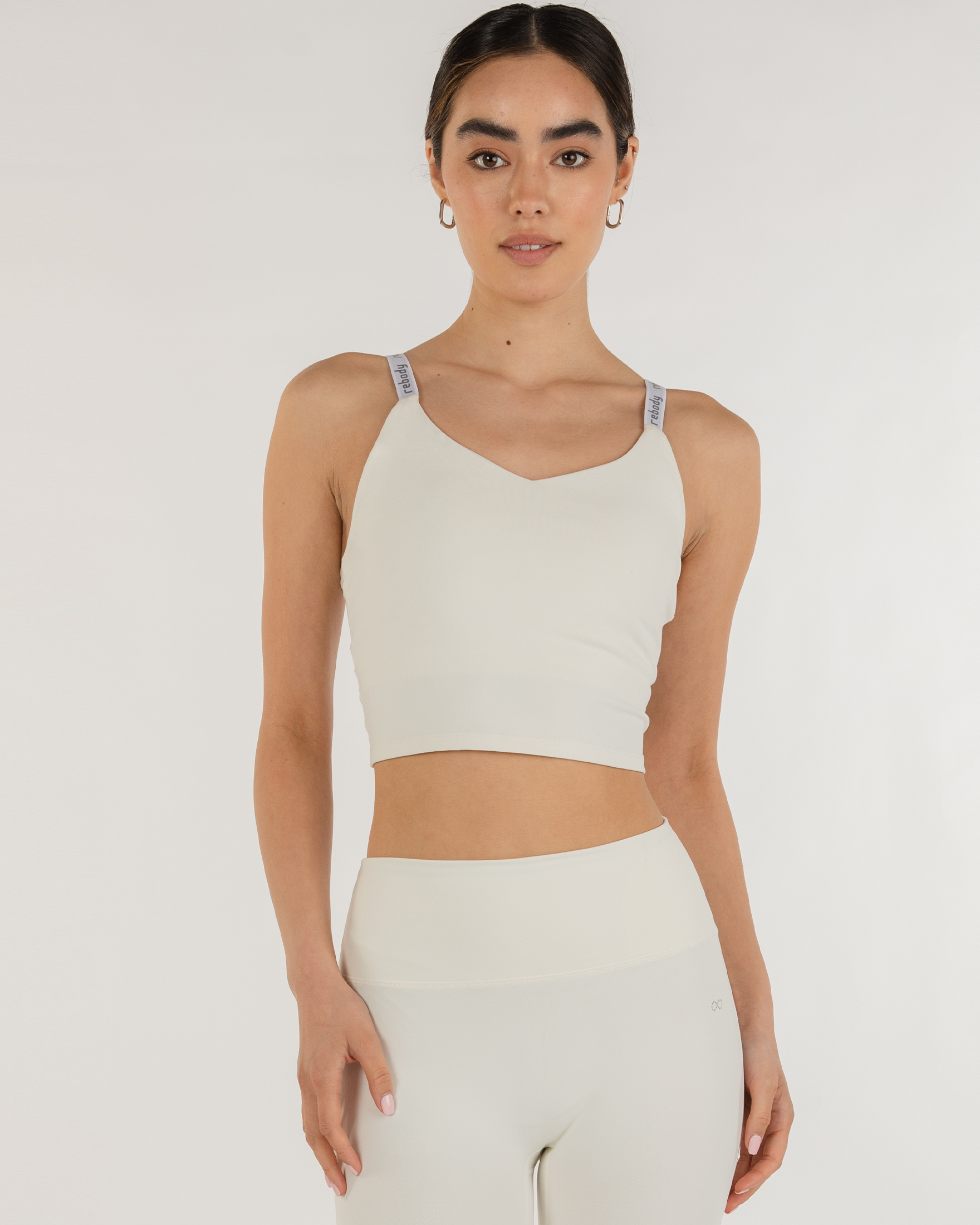 Woman wearing Irynelle Contour Bra Top showcasing its soft scoop neckline and longline fit, ideal for yoga and city walks.