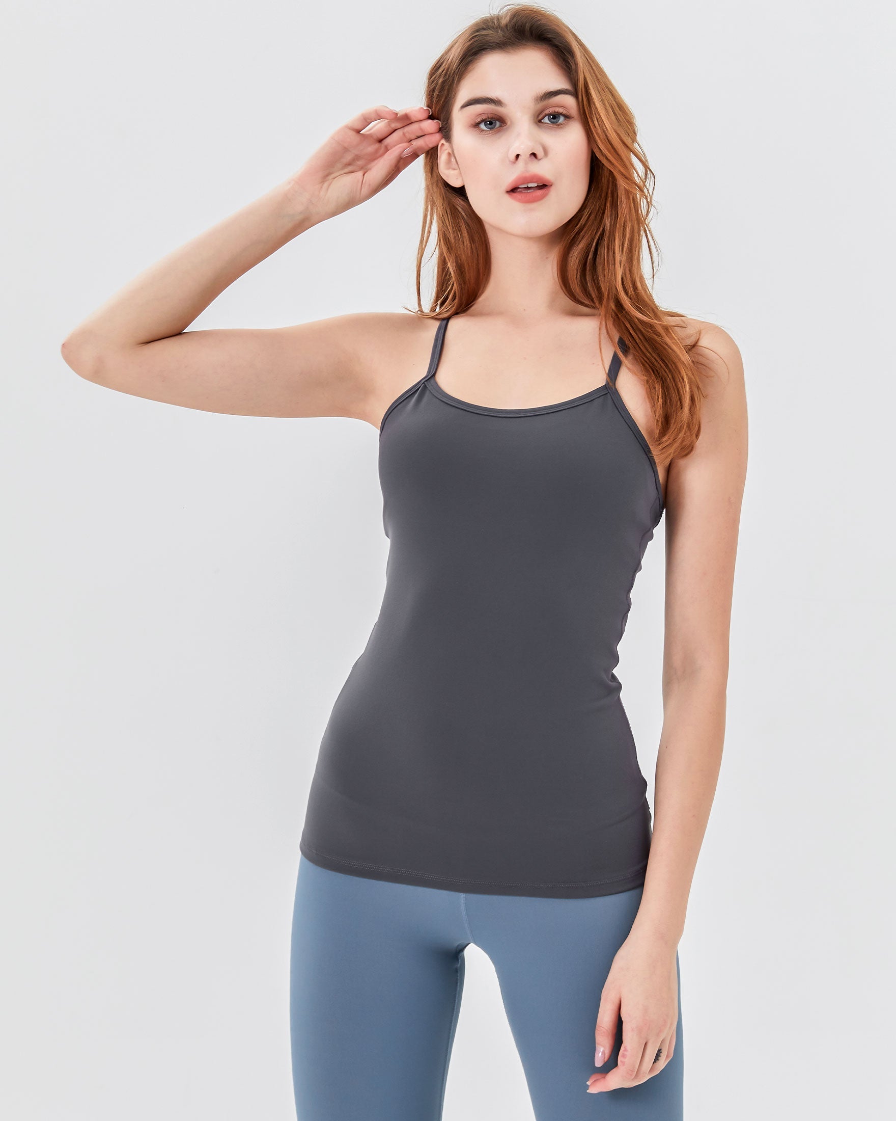 Woman wearing Calriena Motion Bra Tank in gray, perfect for yoga and casual wear, showcasing comfort and fluid motion.