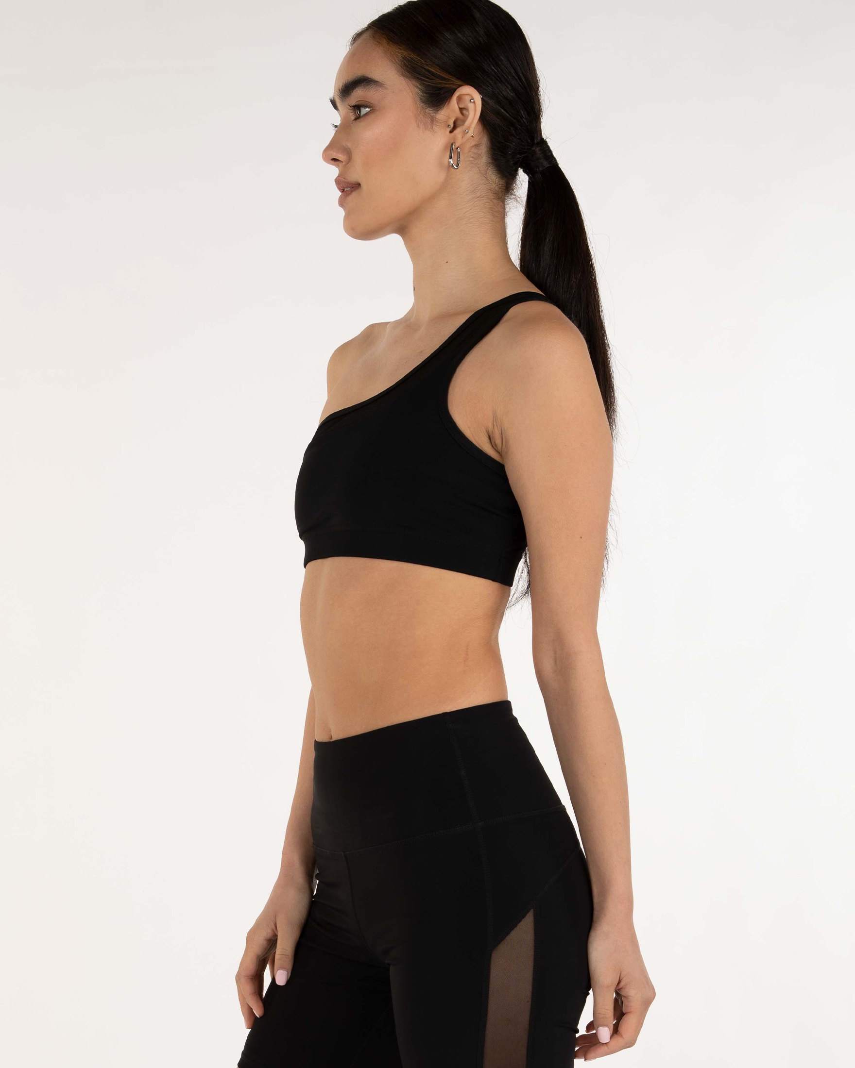 Alt Tag: Woman wearing Narevia One-Shoulder Mesh Bra showcasing sleek design and Silkiflex™ fabric for comfort and style.