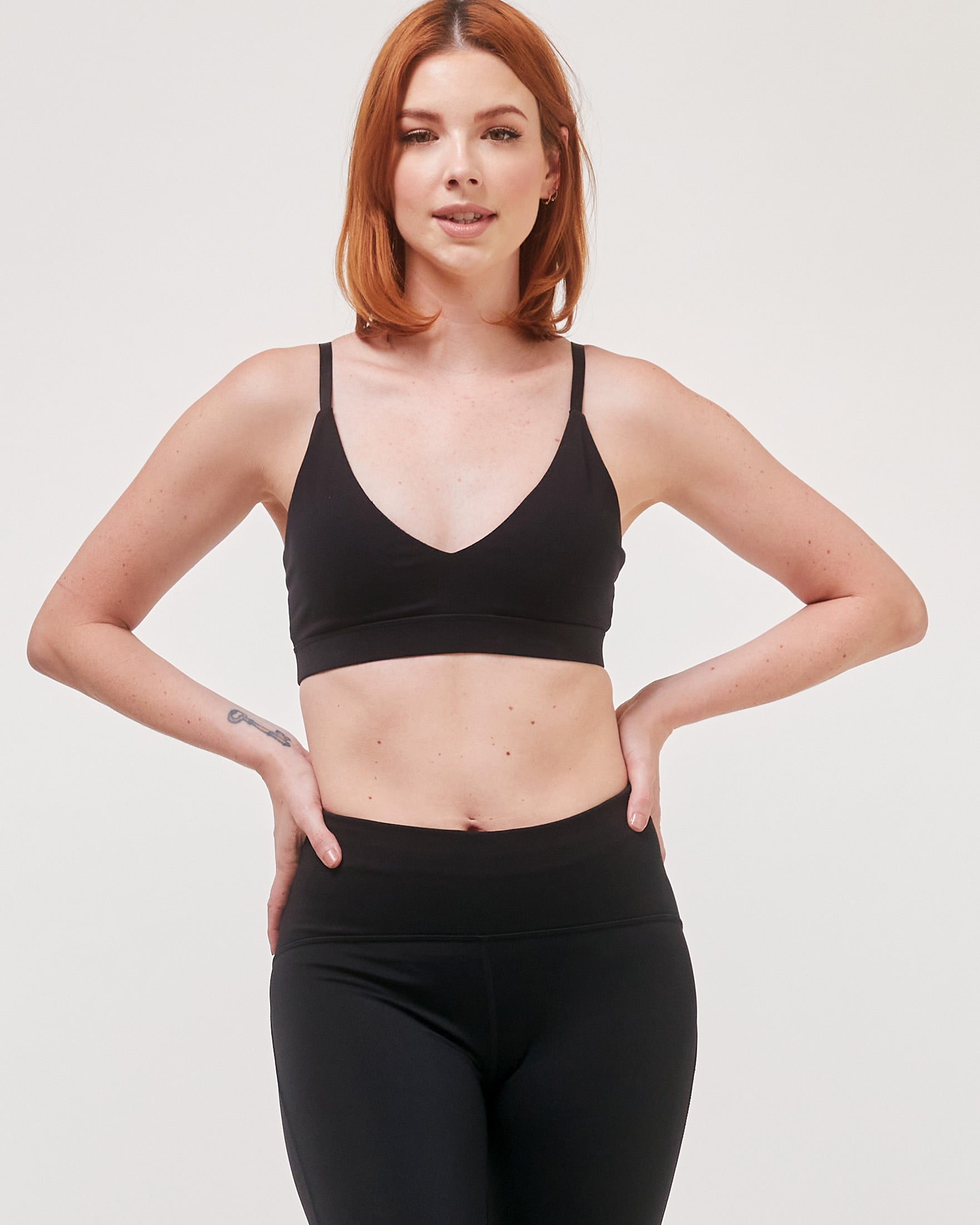 Woman wearing Elyrien Cloudlux Bralette with plunging V-neck, showcasing comfortable fit and optional J-hook for support.