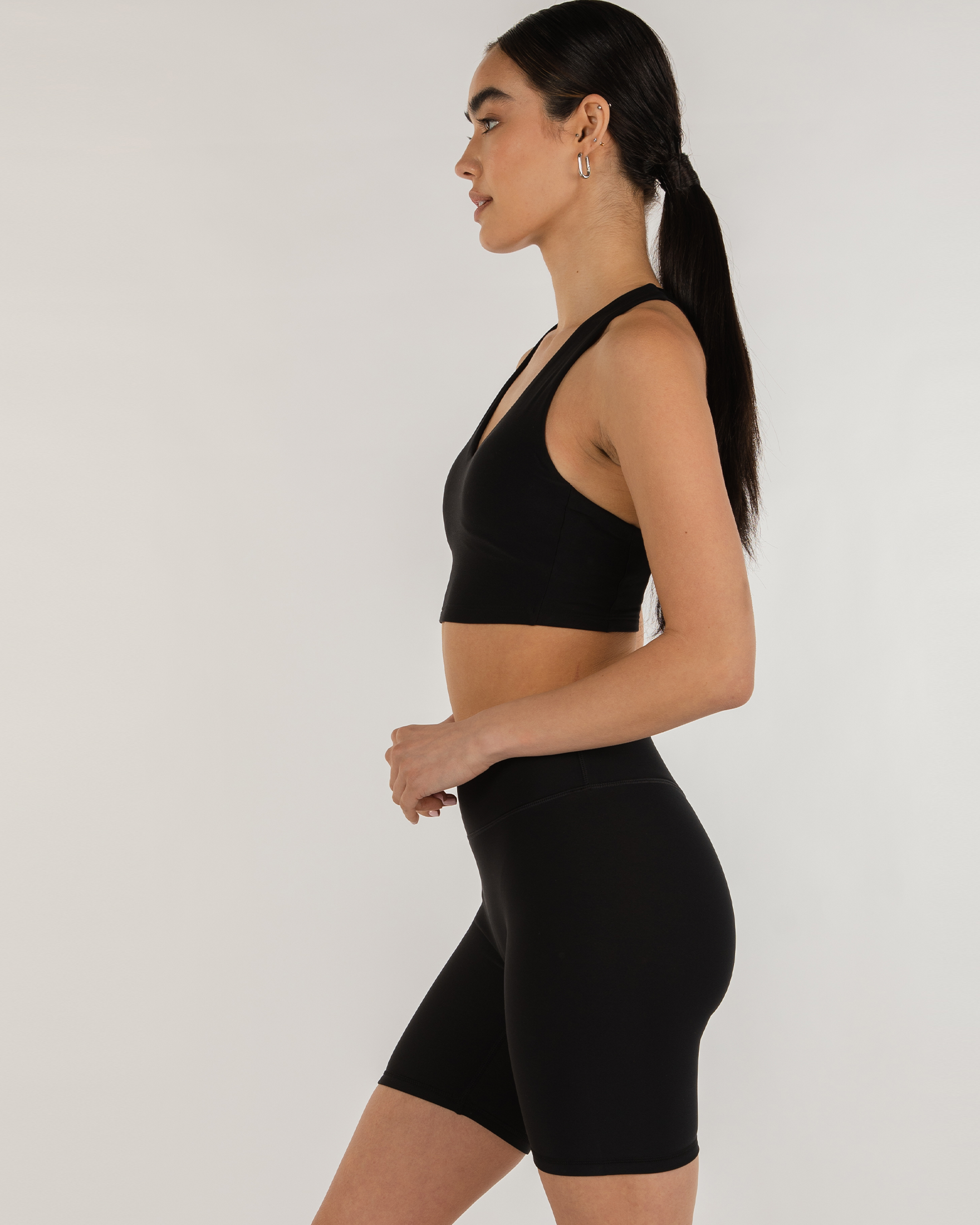 Model wearing Avenysa Warm-Tech Bra, showcasing longline silhouette, deep V neckline, and structured back for movement and warmth.