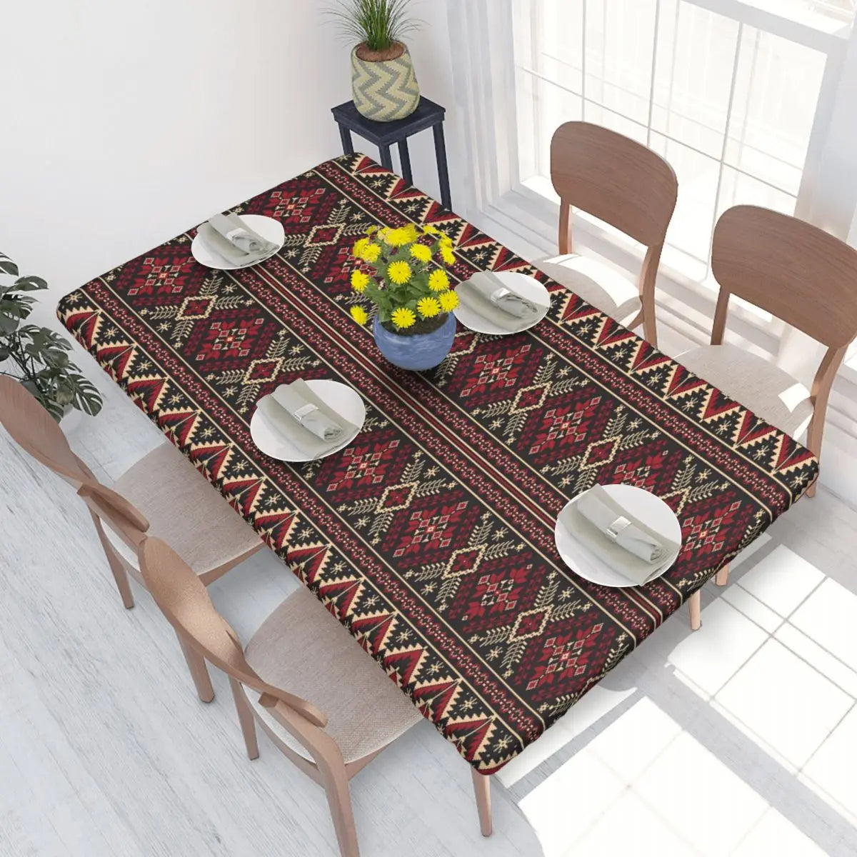 Authentic Ukrainian embroidery table cover on dining table with plates and vase.