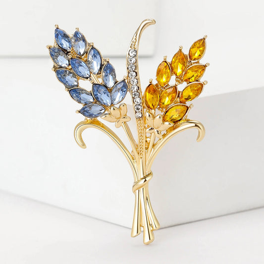 Patriotic Ukrainian Wheat Brooch, handcrafted with blue and yellow stones, symbolizes heritage and elegance.