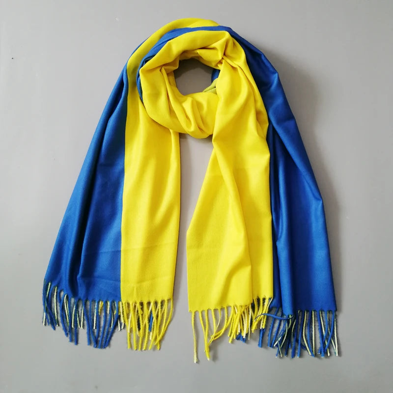 Luxury designer cashmere shawl featuring Ukraine flag colors, elegant winter wrap for women with tassels.