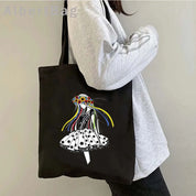 Black tote bag with a Ukrainian patriotic print design, showcasing colorful ribbons on a stylish black and white dress.