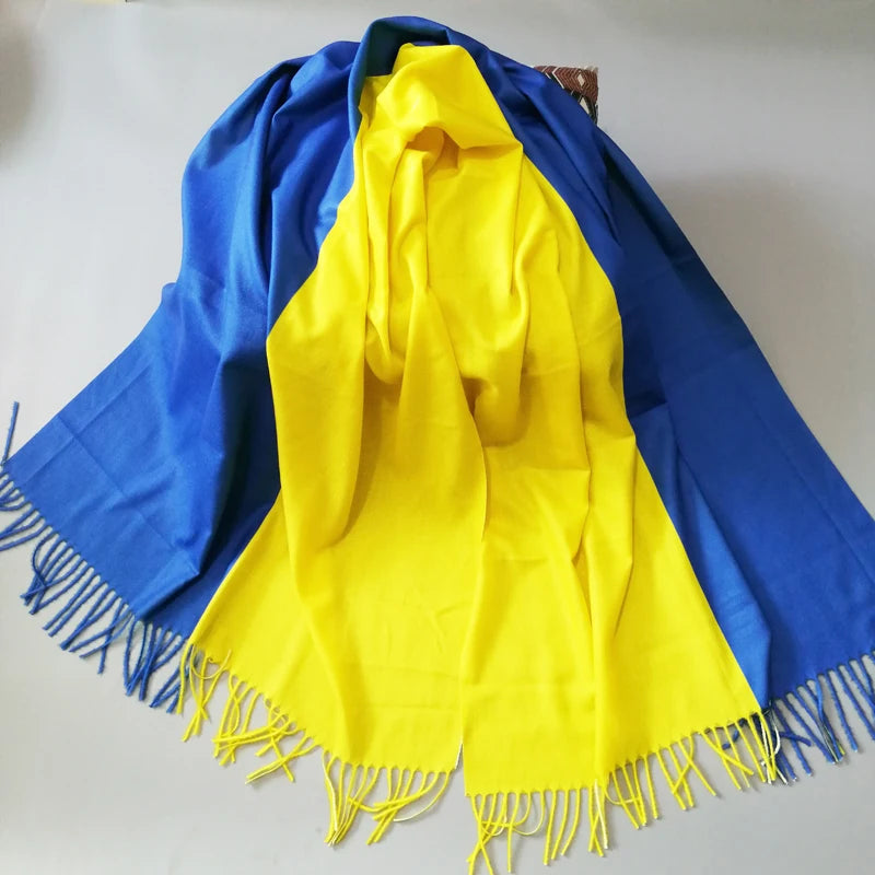 Elegant designer Ukraine flag cashmere shawl in blue and yellow with tassels, showcasing luxury and style for winter warmth.