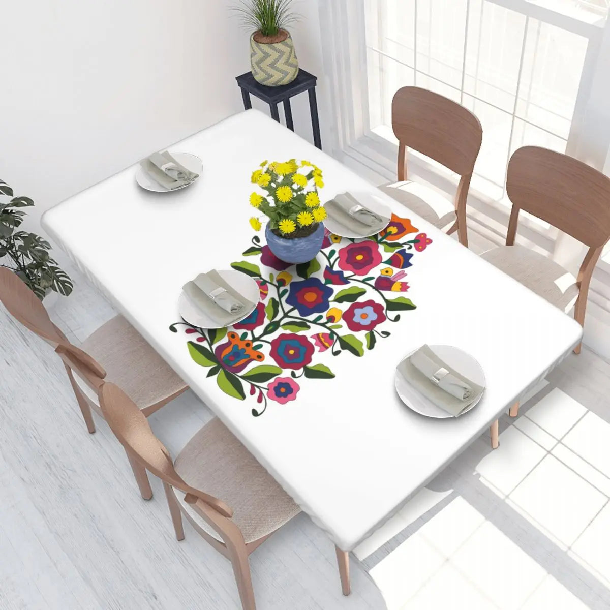 Vibrant Ukrainian embroidery table cover on a dining table set for a meal.