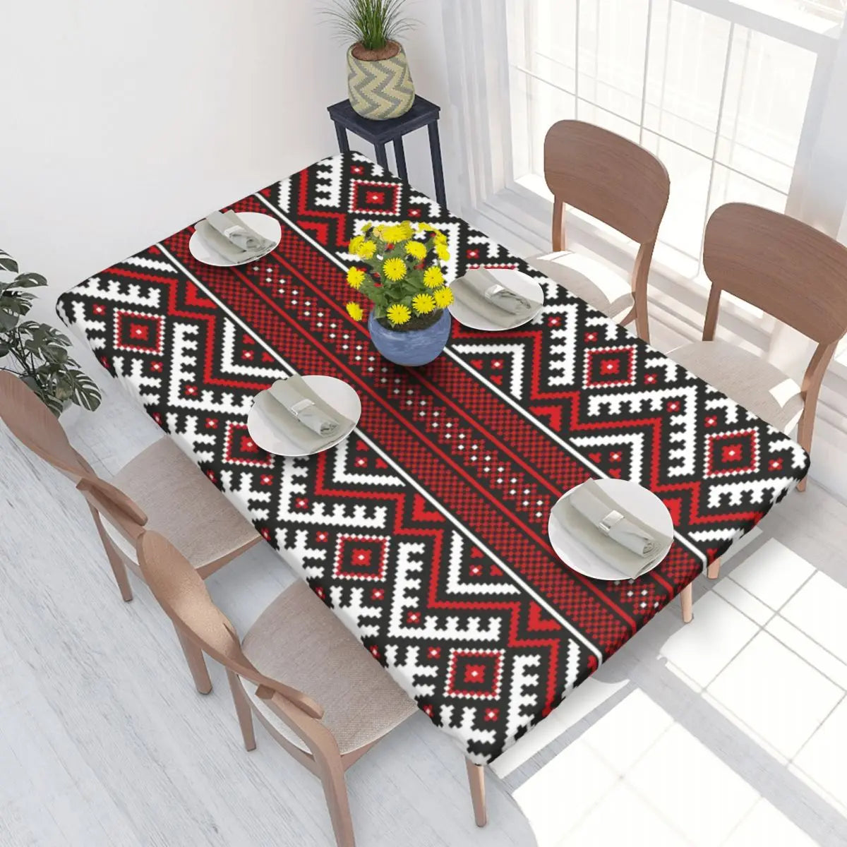 Authentic Ukrainian embroidery table cover on dining table with vibrant red and black patterns, enhancing home decor ambiance.