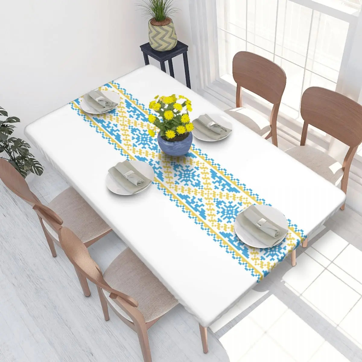 Authentic Ukrainian embroidery table cover on dining table with vibrant blue and yellow pattern, enhancing home decor.