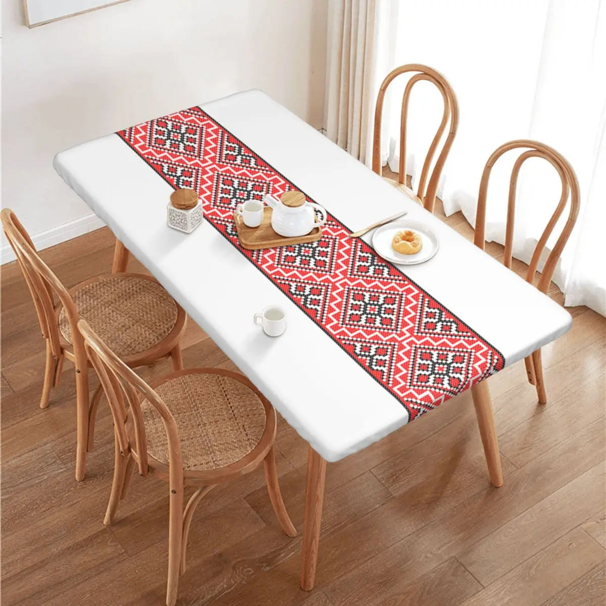 Authentic Ukrainian embroidery table cover on dining table, showcasing intricate patterns and vibrant colors.