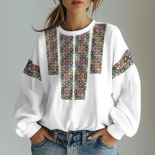 Woman wearing Ukrainian traditional sweatshirt with colorful floral prints, showcasing trendy oversized fashion.