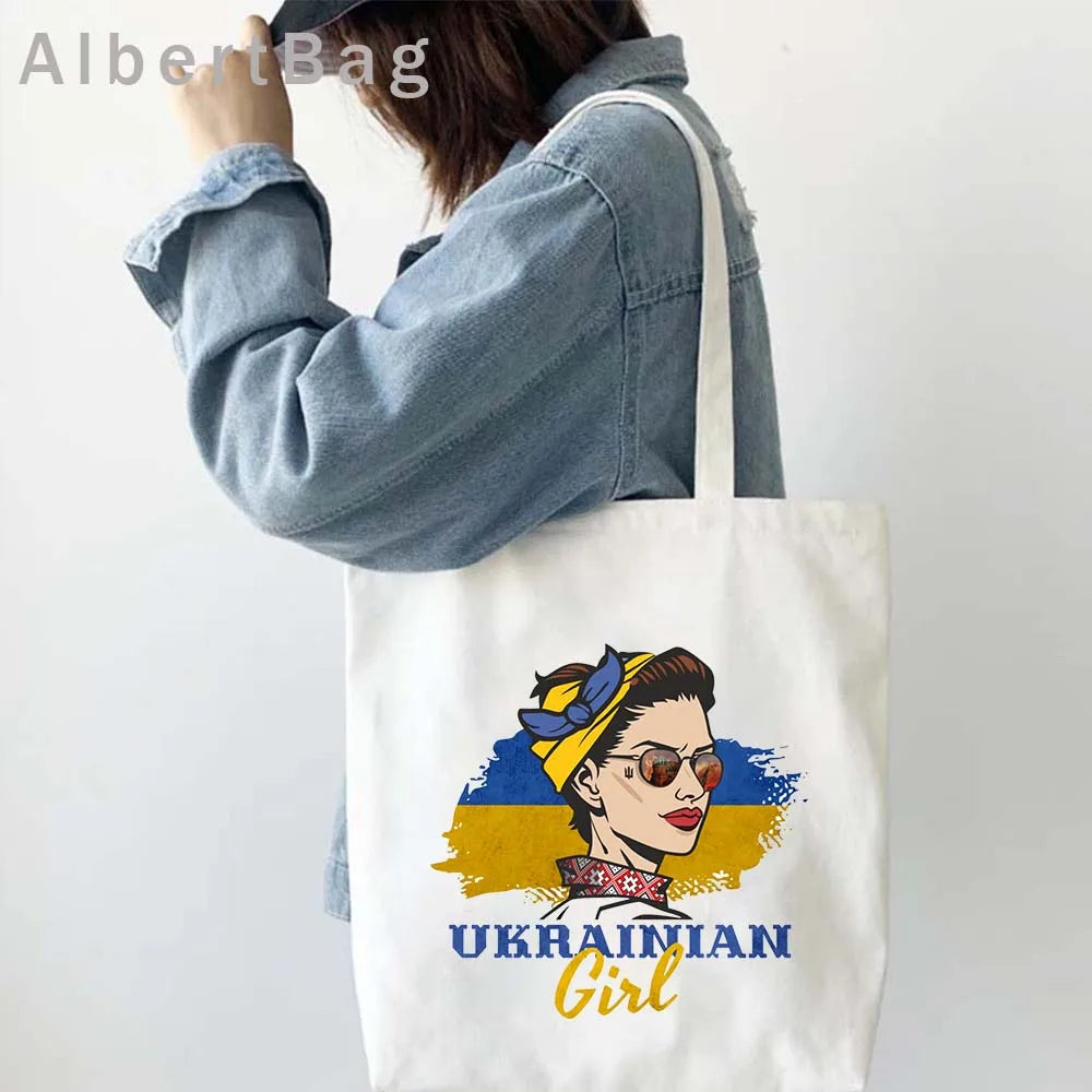 Woman wearing denim jacket carrying Ukrainian Patriotic Grocery Tote Bag with "Ukrainian Girl" design.