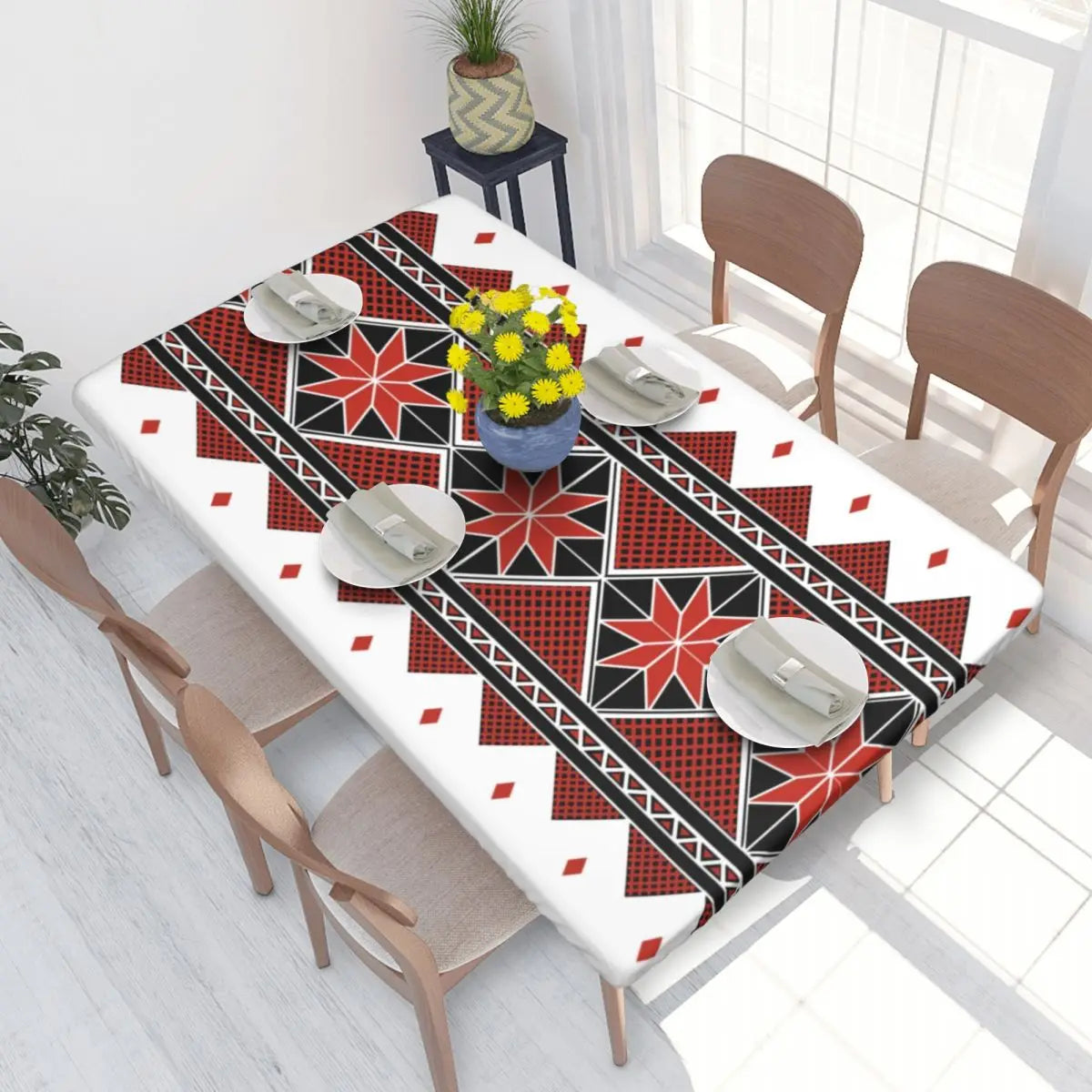 Authentic Ukrainian embroidery table cover with vibrant red and black geometric patterns, enhancing a dining room setting.