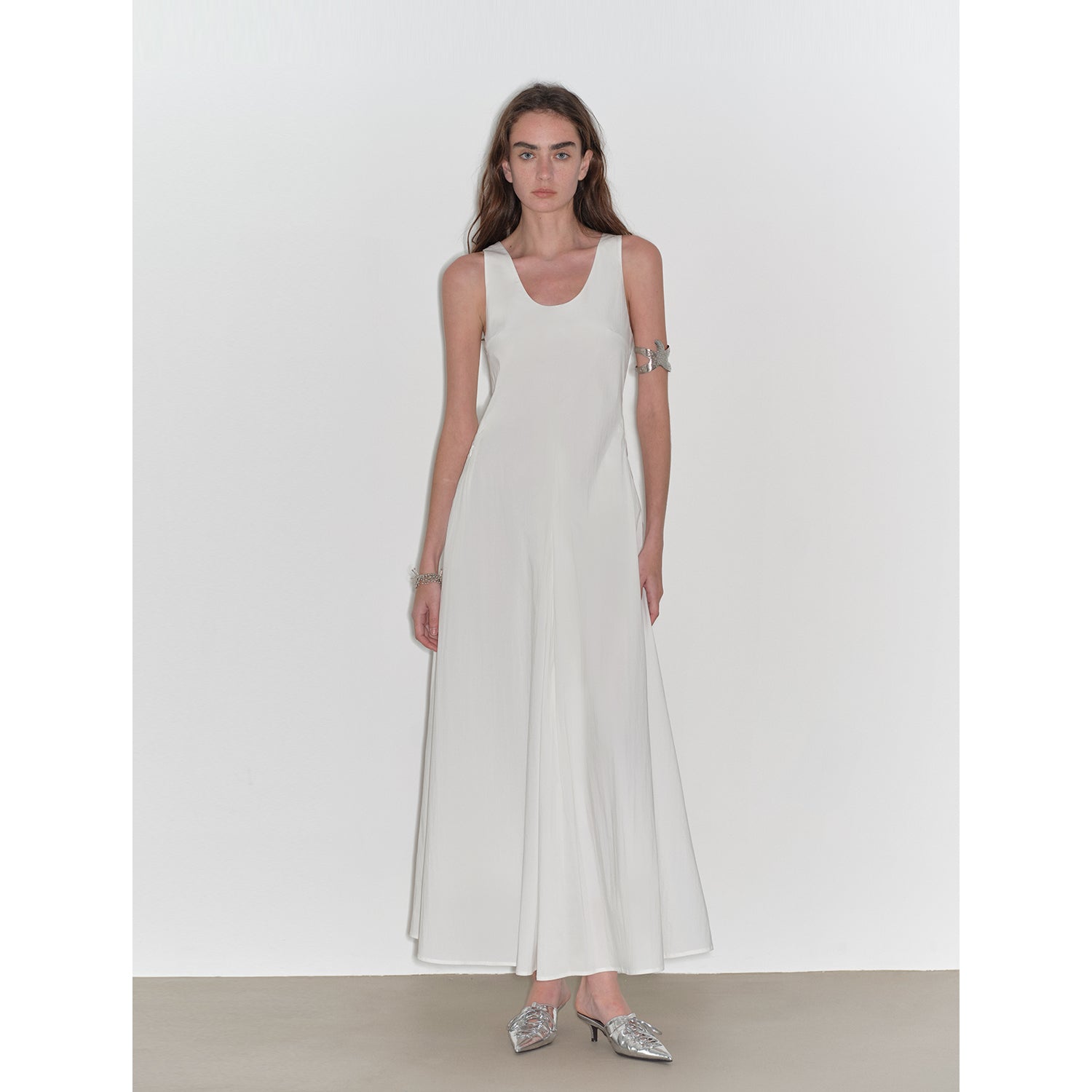 Model wears Lakelyn U-Neck A-Line Vest Dress in white, featuring sleeveless design and A-line hem, crafted from cotton brocade fabric.