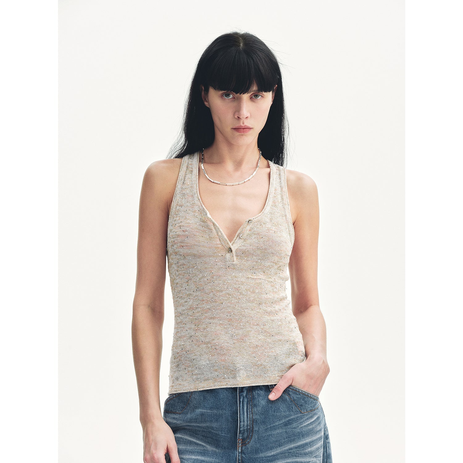 Woman wearing Meredelle Sequin Henley Vest showcasing gradient sequins and Henley neckline, perfect for summer elegance.