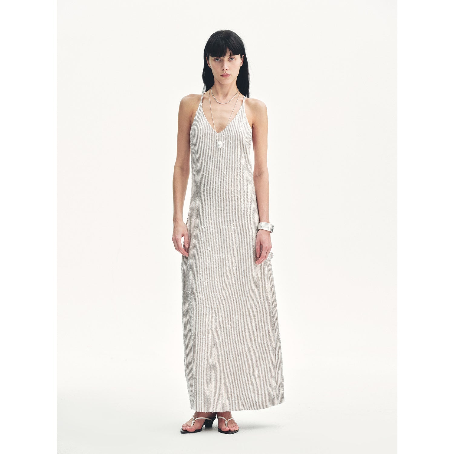 Alt Tag: Astrenya Sequin Linen Maxi Dress with V-neck, thin straps, open back, and sequins for celestial glamour and modern edge.