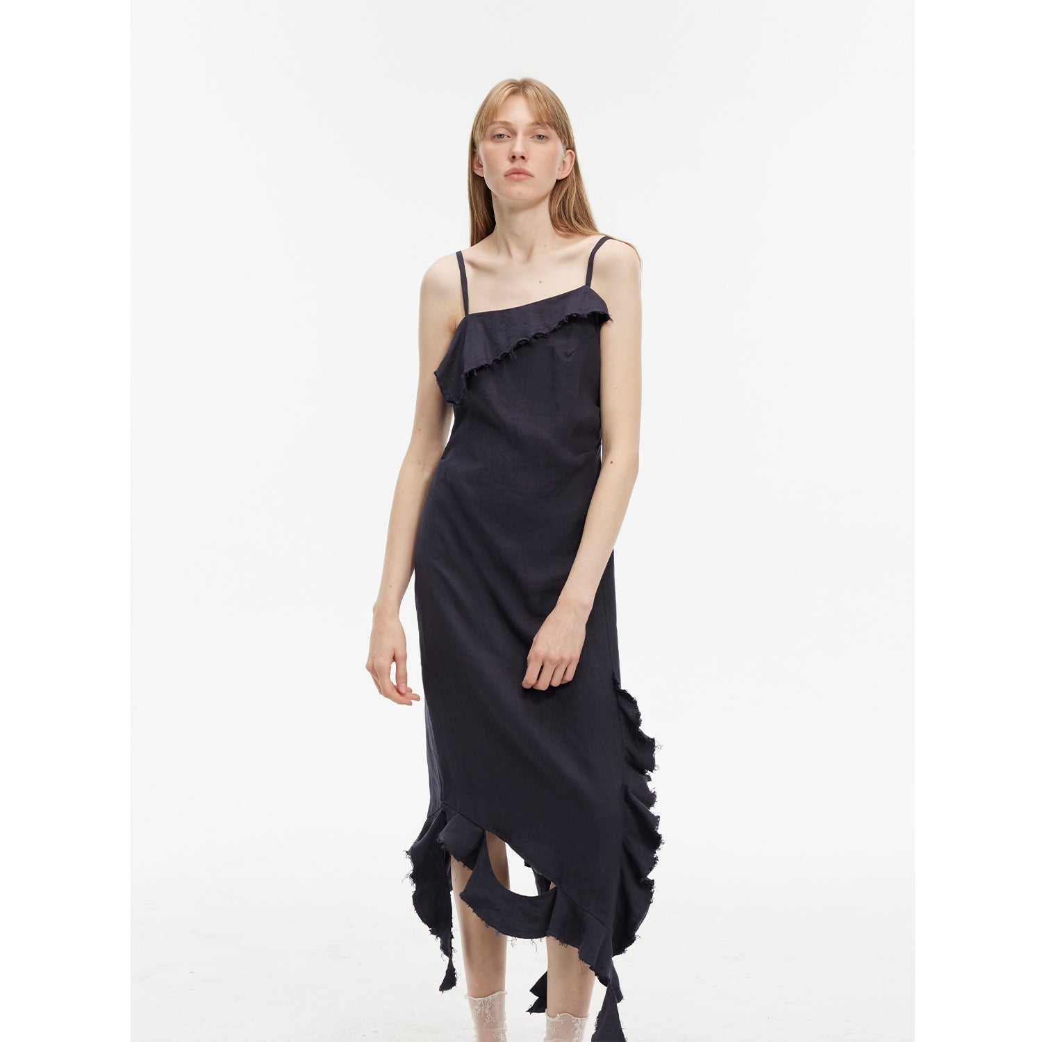Model wearing Elanys Sand-Washed Linen Ruffle Dress with asymmetric neckline and flowing silhouette for a romantic summer look.