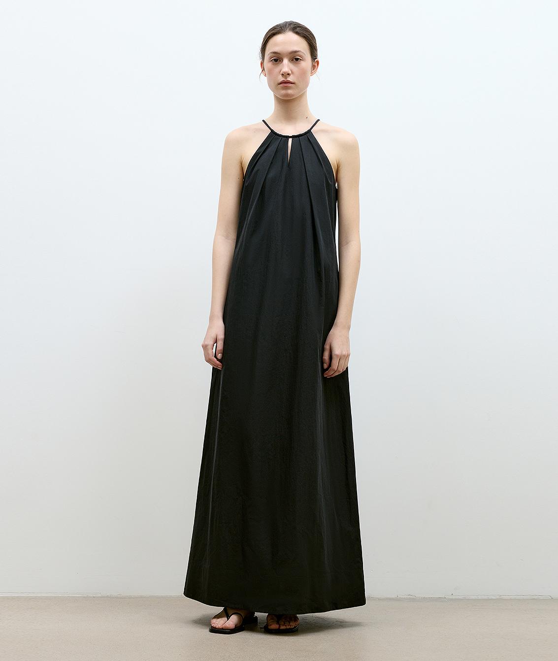 Black Veridia Halter-Pleat Maxi Dress with cotton-rope halter and V-shaped cut-out, featuring a pleated neckline and fluid ankle-length skirt.